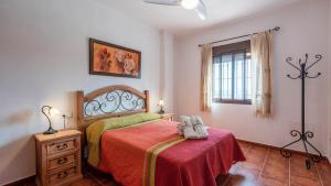 a bedroom with a bed with a red blanket at Cortijo Sylvestris Periana by Ruralidays in Periana +20 photos