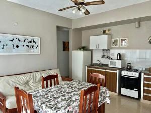 a kitchen with a dining room table and a kitchen with a table and chairs at Altos de Artusi in Concepción del Uruguay