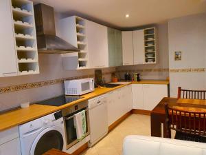 a kitchen with a washing machine and a microwave at LUXURY HOUSE-HERMOSA VIVIENDA LUJO-APPART DE LUXE in Madrid