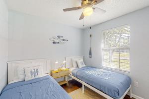 a bedroom with two beds and a ceiling fan at Dog-friendly home with fenced yard, patio, grill, & park across the street in Saint Augustine