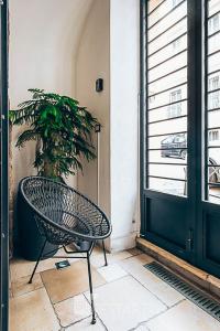 a chair sitting on a porch next to a plant at Restart Accommodations Ada in Rome