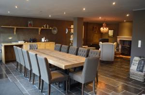 a dining room with a wooden table and chairs at Veld en Bosch in Leusden