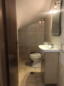 a bathroom with a toilet and a sink at Seaside Villa in Preveza
