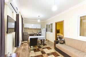 a living room with a table and a couch at Herton Apart Hotel in Istanbul