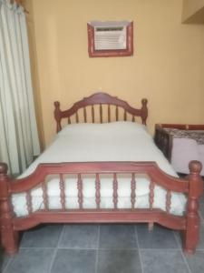 sypialnia z drewnianym łóżkiem w pokoju w obiekcie Inti Mayu w mieście Villa Cura Brochero