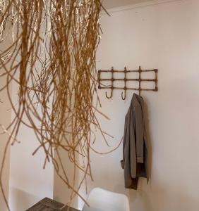 a jacket hanging on a wall next to a chair at Departamentos Duarte Quiros in Cordoba