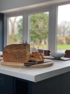 a piece of cake on a cutting board on a table at New purpose built holiday lodge in Scorton