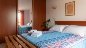 a bedroom with a bed with towels on it at Welcomely - Gabbiani - Cala Gonone in Cala Gonone