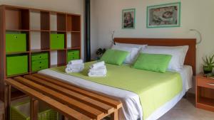 a bedroom with a bed with green and white at Welcomely - Gabbiani - Cala Gonone in Cala Gonone