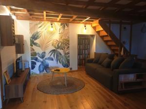 a living room with a couch and a table at Gîte du Fassac in Saint-Julien-du-Puy