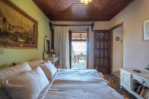 a bedroom with a large bed and a couch at Guest House Sklithro in Sklíthron