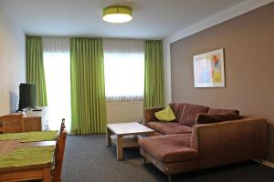 a living room with a couch and a table at Gasthof Alte Schule in Fürstenzell