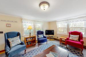 a living room with two chairs and a tv at Nauset Beach Dream in Orleans