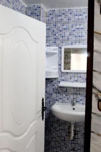 uma casa de banho com um lavatório e um espelho em Titrit House awrir em Aourir