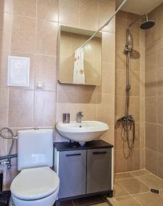 a bathroom with a toilet and a sink and a shower at Cozy 2BD Apartment in Bansko in Bansko