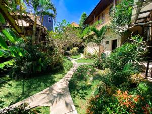 a path through the garden of a resort at Home-Bience Hostel in Uluwatu