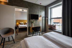 a hotel room with a bed and a table and chair at Aalborg Airport Hotel in Aalborg