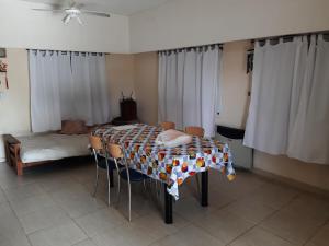 a room with a table with chairs and a bed at Casaquinta en Funes in Funes