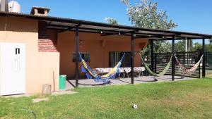 a covered patio with hammocks in a house at Casaquinta en Funes in Funes