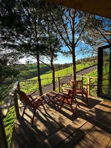 two chairs and a table on a porch with a view at Valley View Pendle in Foulridge