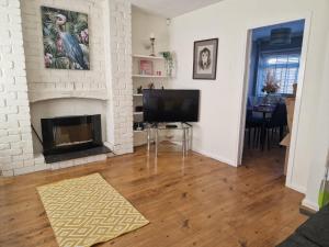 a living room with a fireplace and a television at 4 beds with links to motorways in Leeds