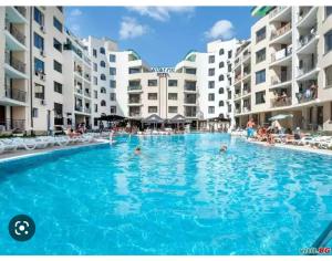 a large swimming pool in front of some apartment buildings at Аз и Ти in Sunny Beach