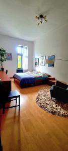 a bedroom with a bed and a ceiling fan at City center apartment in Sopron