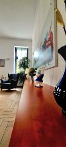a living room with a large painting on the wall at City center apartment in Sopron +2 photos