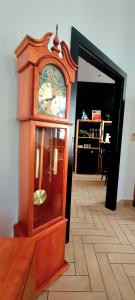 a grandfather clock sitting on top of a wooden floor at City center apartment in Sopron