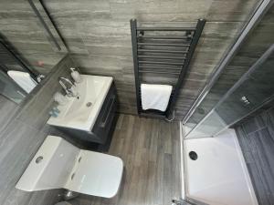 an overhead view of a bathroom with a sink and a shower at Pen Mar Guest House B&B in Tenby