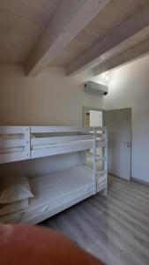 an empty room with white bunk beds in it at Appartamento cavalluccio marino in Porto Potenza Picena