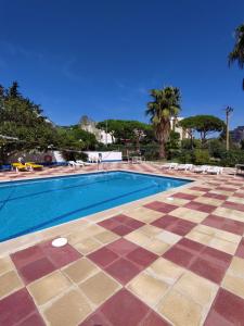 a swimming pool with a checkered floor next to a resort at Raco d'en Pepe in Calella