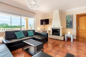 a living room with a couch and a fireplace at Villa next to playa Bossa in Sant Josep de sa Talaia