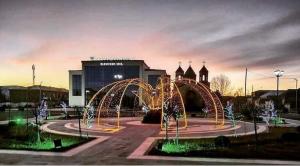 a park with a fountain in front of a building at Отдых в Ташире in Vorontsovka