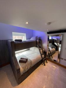 a bedroom with two bunk beds and a mirror at Belvedere Aparthotel - 83 Mount Pleasant in Liverpool