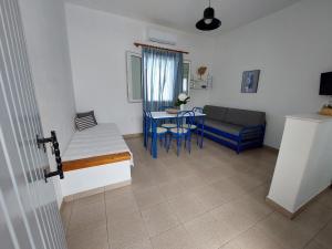 a small living room with a table and a couch at Paros Reppas House "Livadia" in Parikia