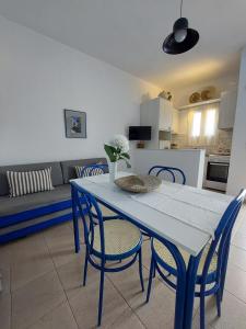 a blue table and chairs in a living room at Paros Reppas House "Livadia" in Parikia