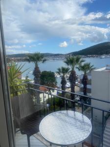 a balcony with a table and a view of the water at Eva Otel Çeşme in Cesme