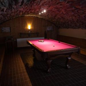 a red pool table in a room with an attic at Pensionat Mullfjället in Duved