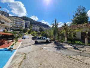 a car parked in a parking lot next to a pool at Zigos Apartments in Igoumenitsa