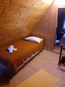 a bedroom with a bed in a wooden room at Matanovi dvori in Bribir