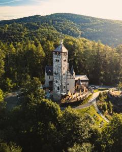 an old castle in the middle of a forest at Wellness Hotel Liberecká Výšina in Liberec