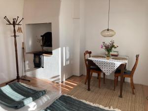 a dining room with a table and chairs and a mirror at Förtjusande gästsvit med öppen spis in Höör