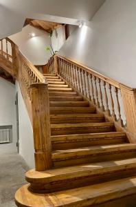 a staircase in a building with wooden steps at Home Sweet Home in Rīga