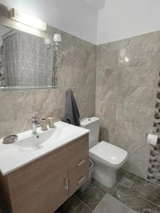 a bathroom with a sink and a toilet at Rhodes Central: King Bed Studio in Rhodes Town +14 photos
