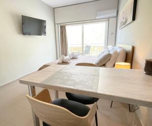 a dining room with a table and chairs at Rhodes Central: King Bed Studio in Rhodes Town