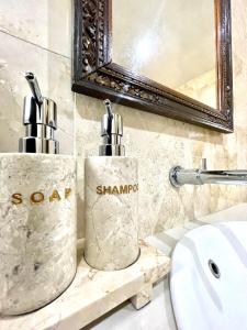 a bathroom with two soap dispensers on a sink at DIMUWA Ubud in Ubud