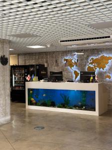 a large aquarium in a lobby with a large fish tank at GOOD-VIBES Apartments in Batumi