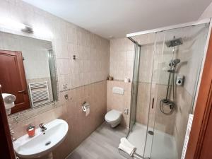 a bathroom with a shower and a sink and a toilet at Tavel boutique hotel in Prešov +23 photos