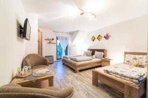 a living room with a couch and a bed at Penzión Zunama in Bardejovské Kúpele